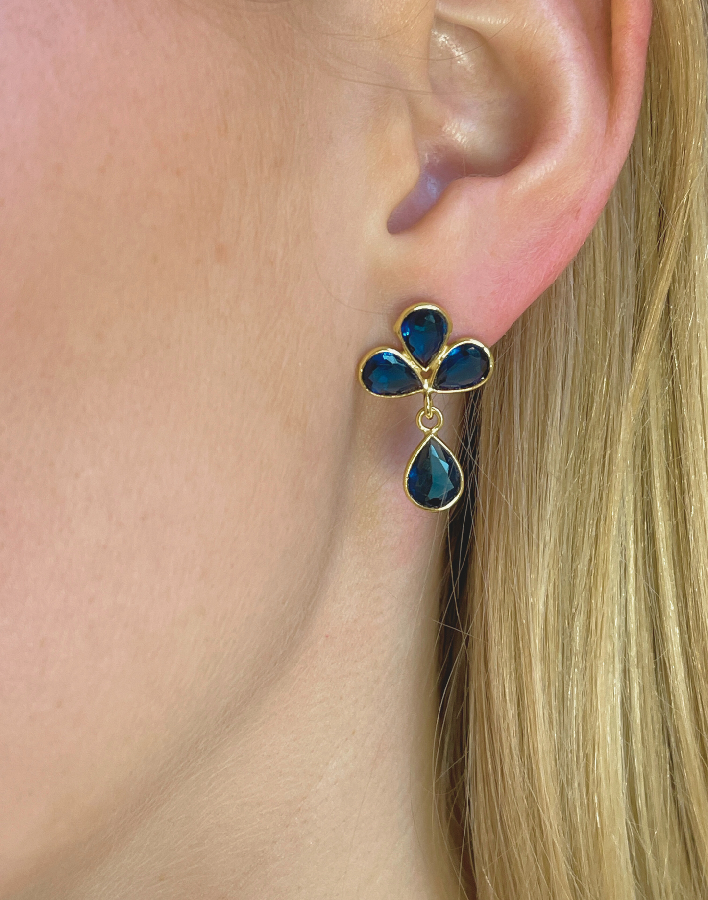 model wears petal dark blue earrings