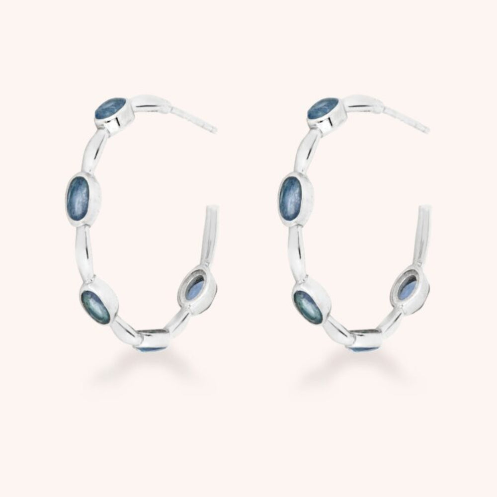 Apatite gemstone silver hoops on white background