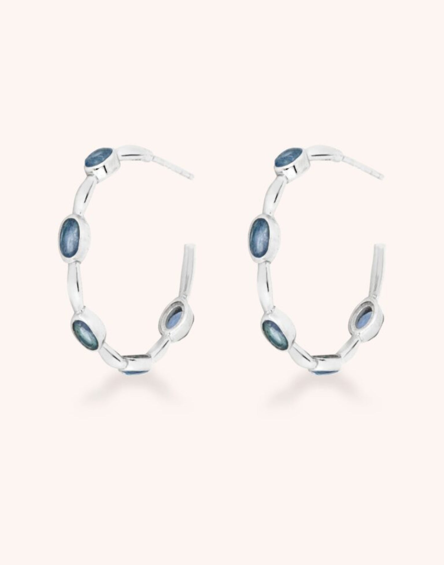 Apatite gemstone silver hoops on white background