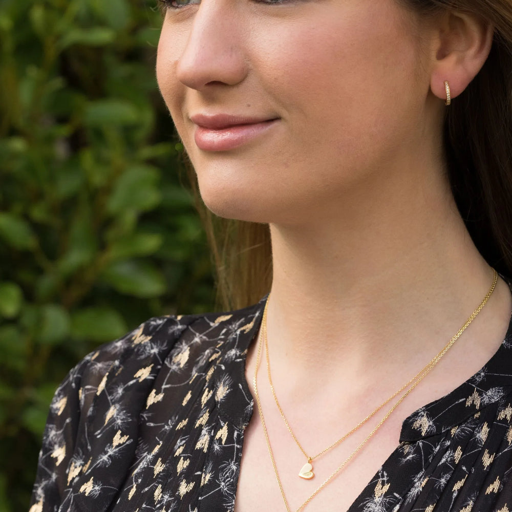 model wears April birthstone White topaz huggie earrings