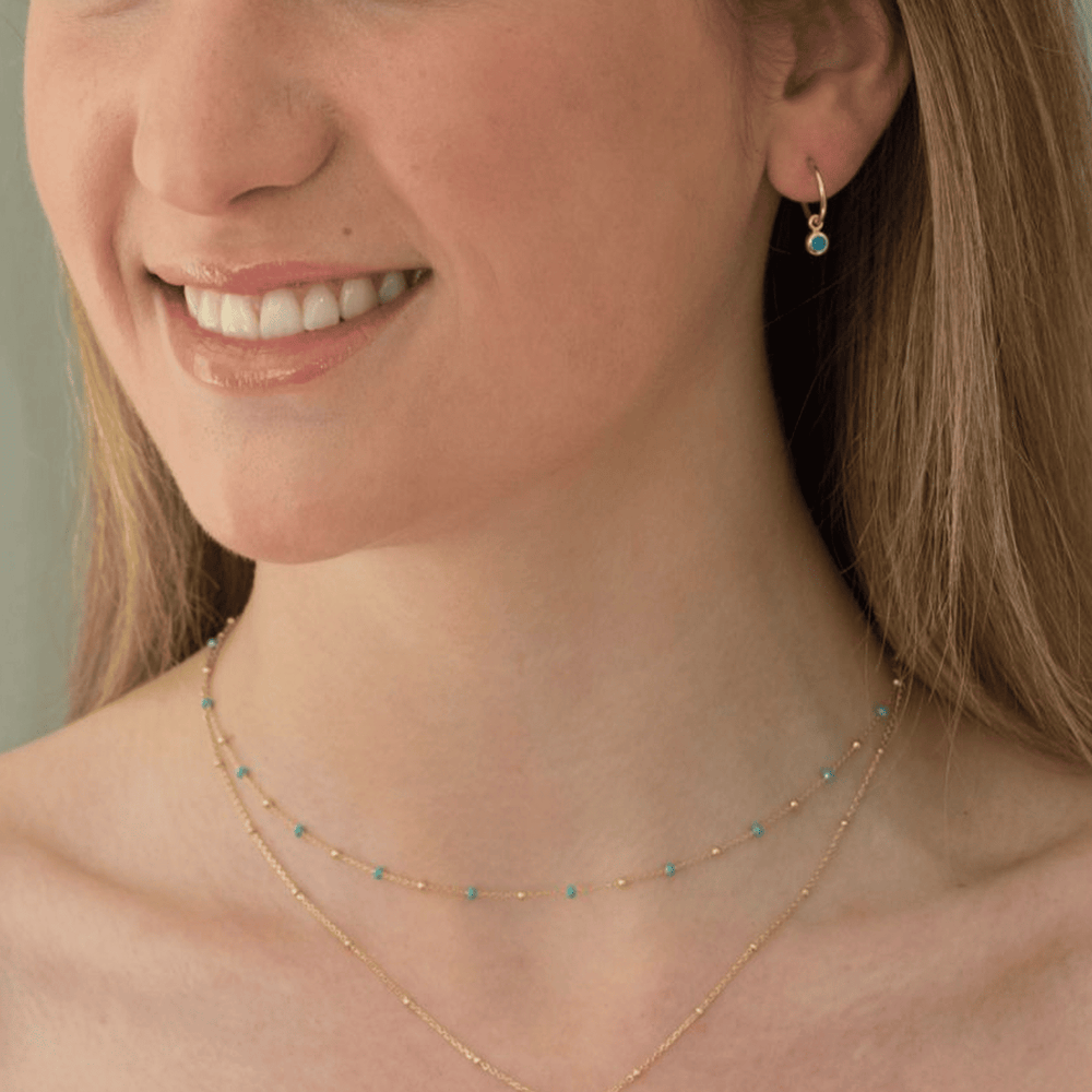 Astrid gold necklace layered with enamel necklace