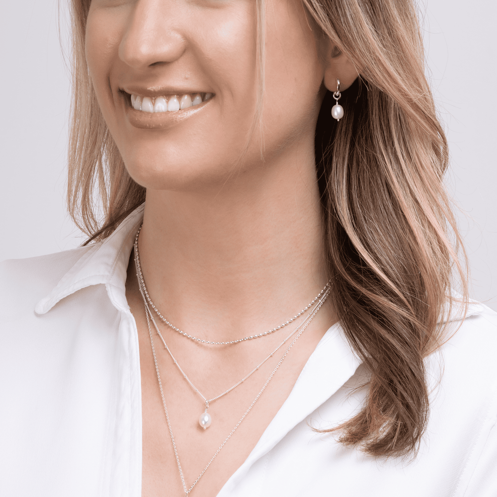 Model wears baroque pearl pendant