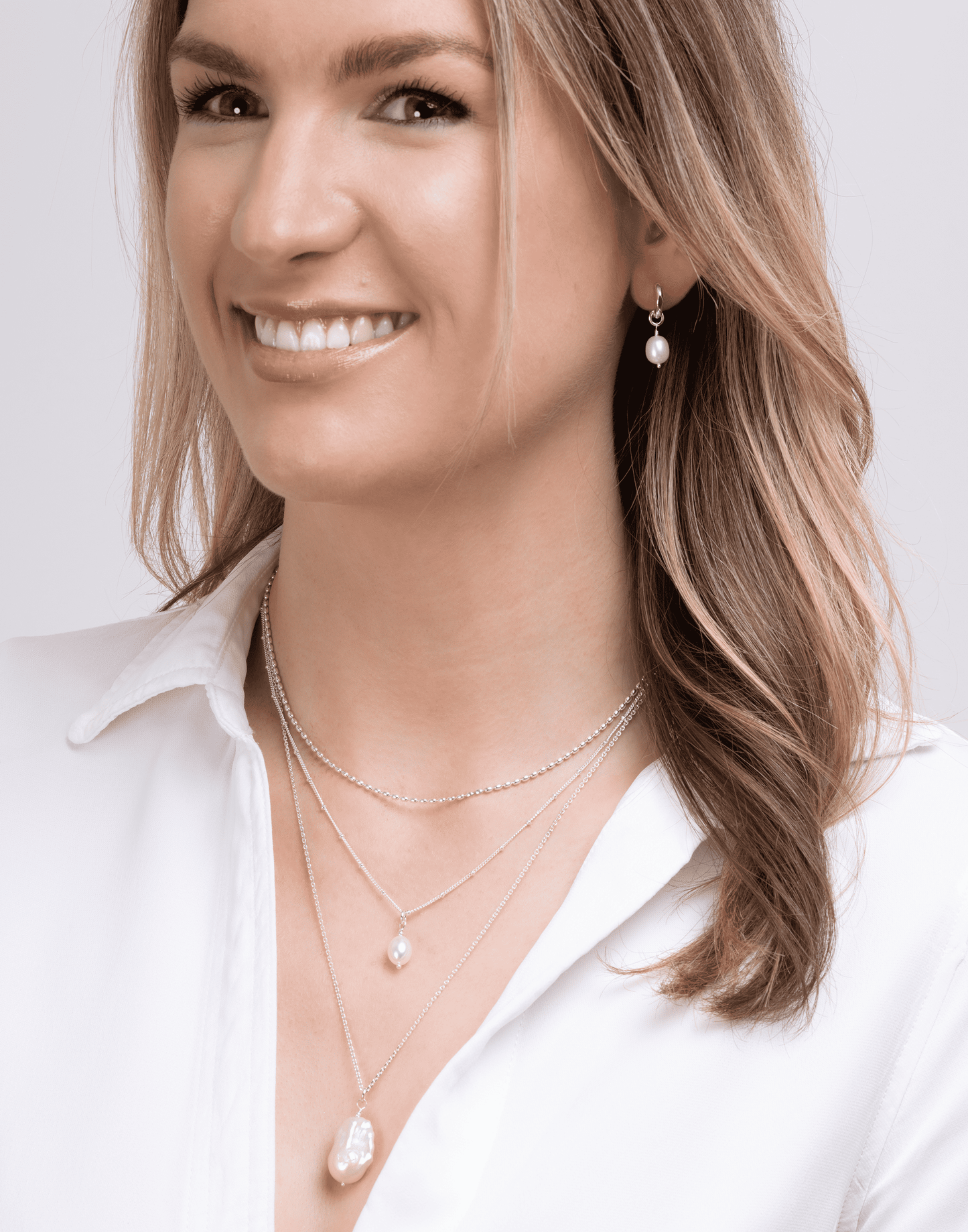 Model wears baroque pearl pendant