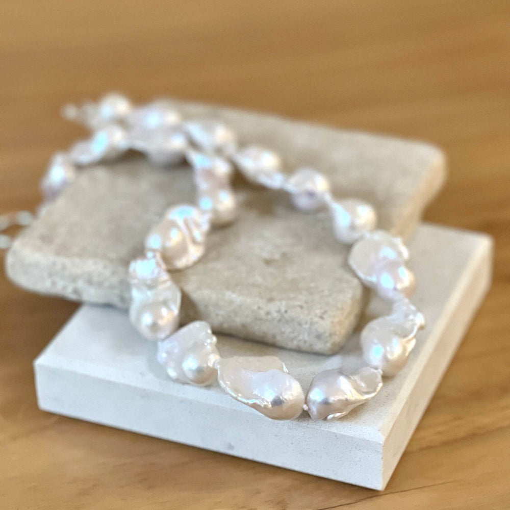 Baroque pearl necklace on tile