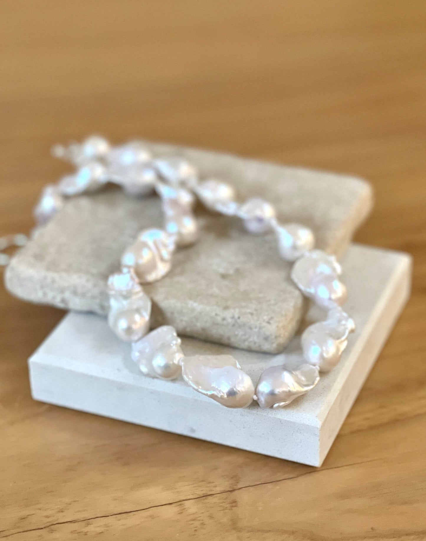 Baroque pearl necklace on tile
