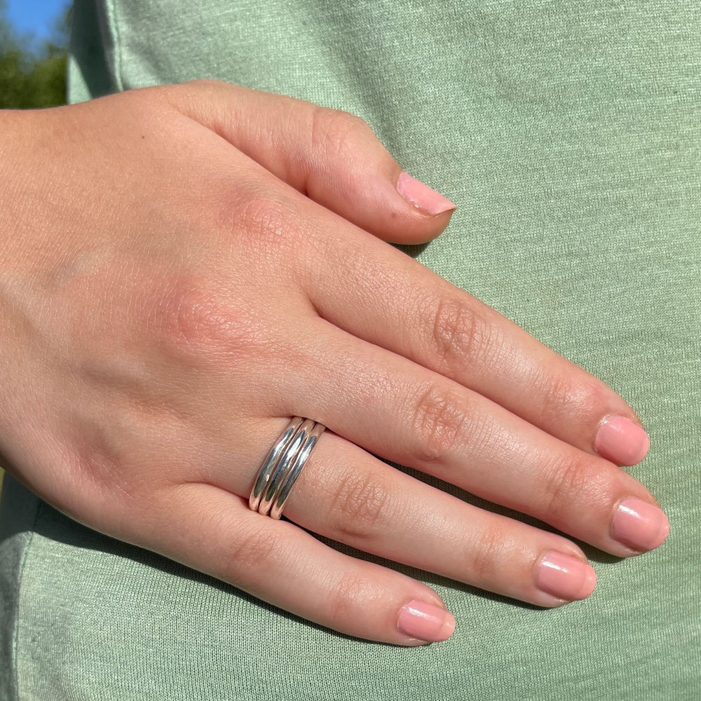 Model wears Silver chunky ring with three bands