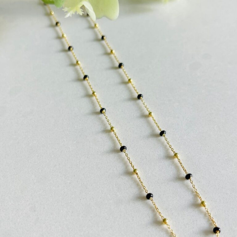 
                  
                    Gold black enamel necklace with black beads 
                  
                