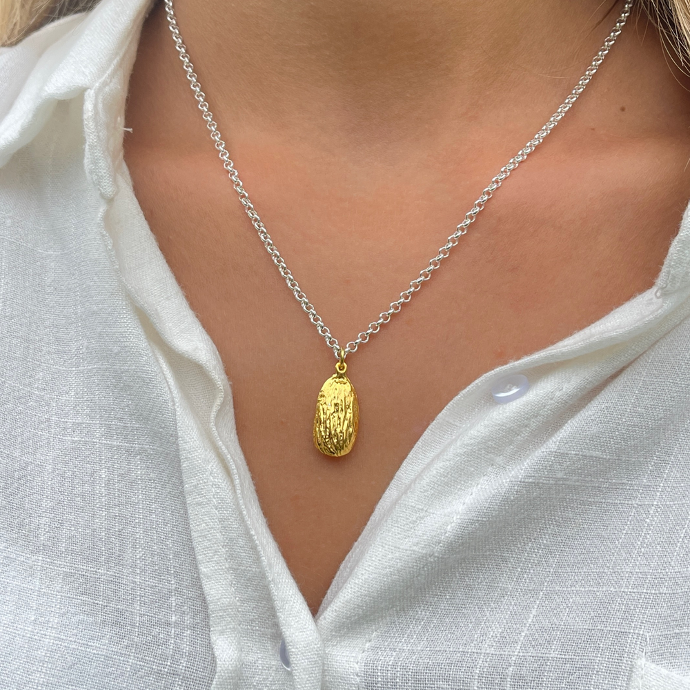 model wears gold almond necklace