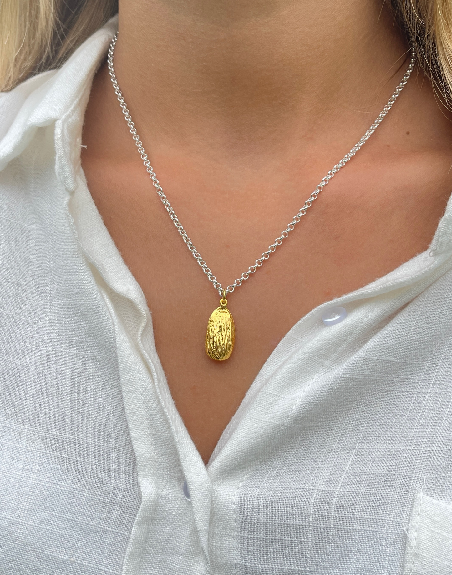model wears gold almond necklace