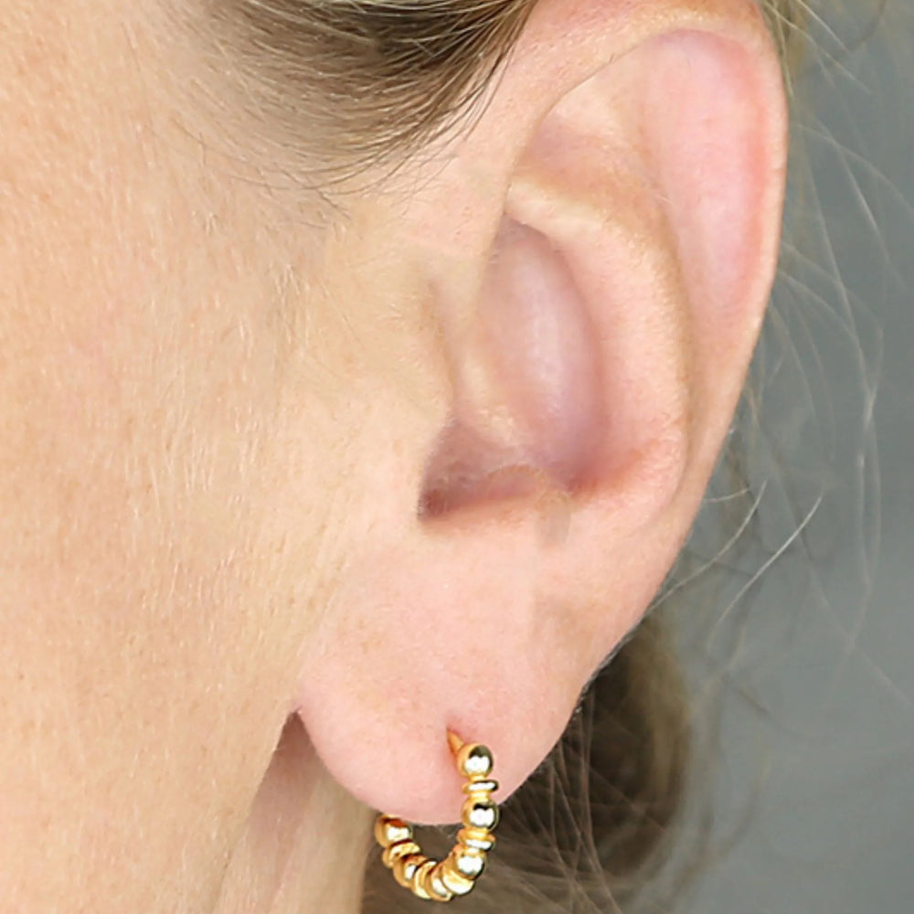 Gold Bobble Huggies in ear
