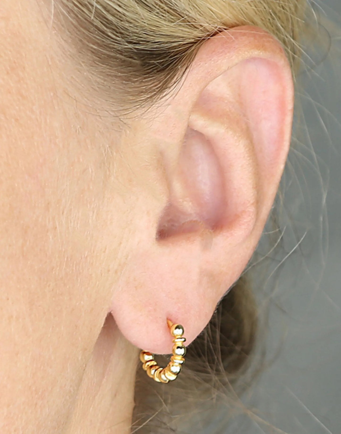 Gold Bobble Huggies in ear
