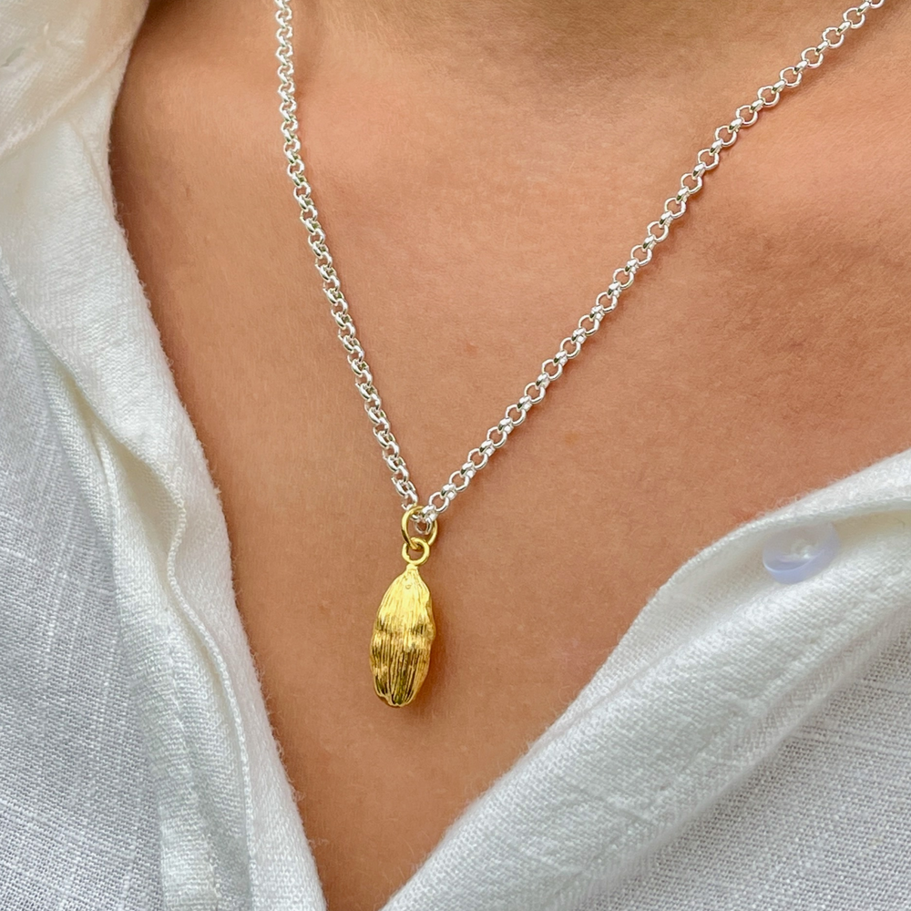 close up of gold cardamon necklace