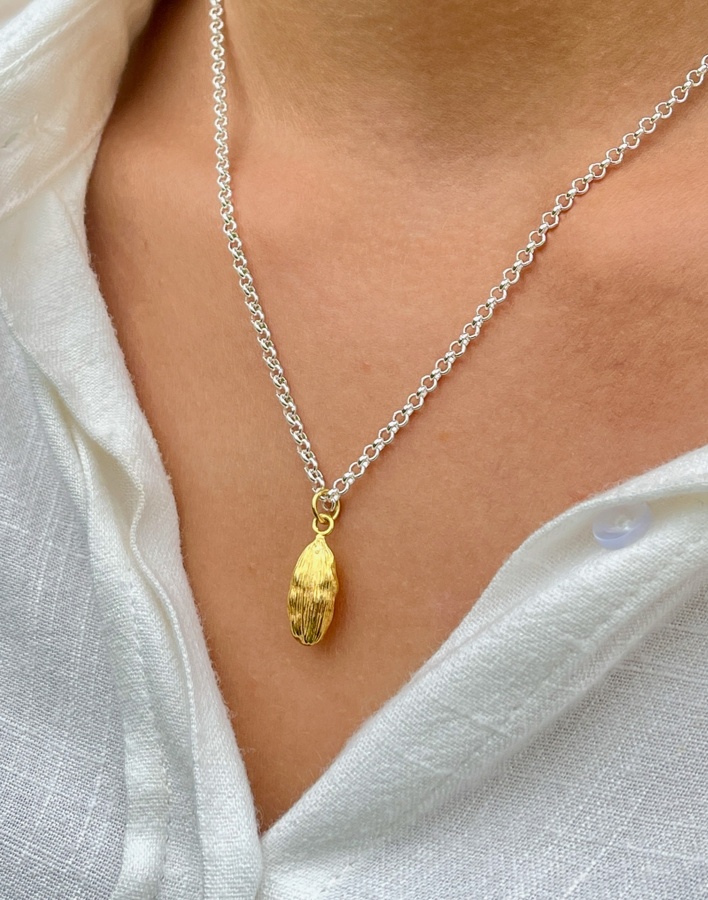 close up of gold cardamon necklace