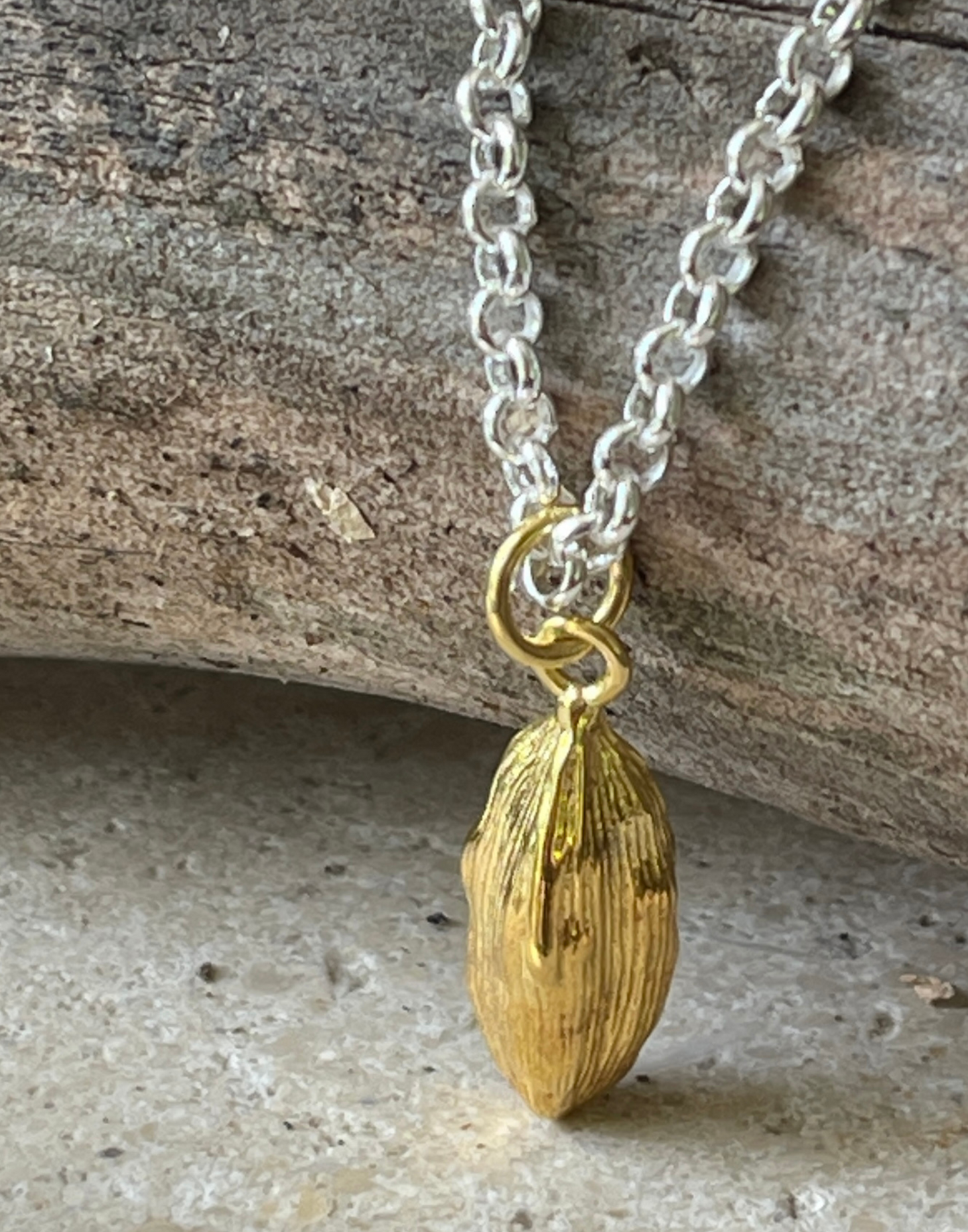 Gold cardamon necklace on branch
