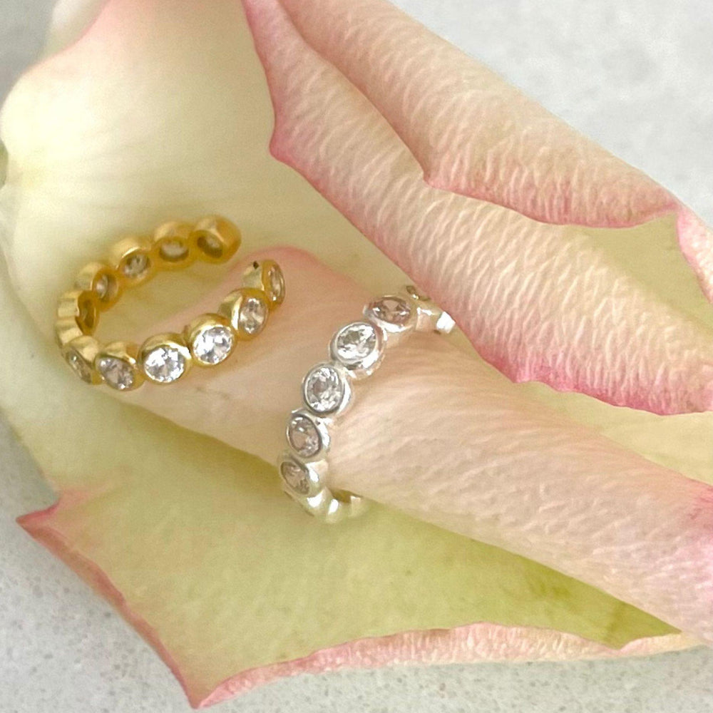 
                  
                    Gold CZ ear cuff with silver CZ ear cuff on petal
                  
                
