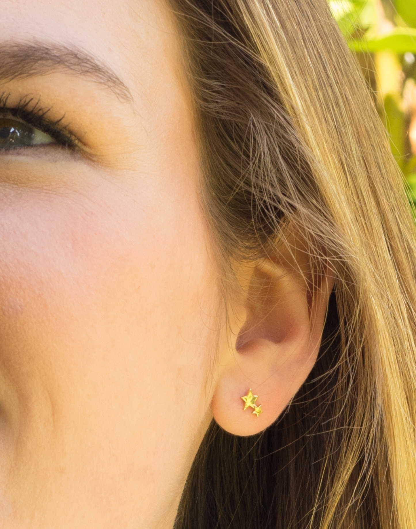 model wears gold double star studs