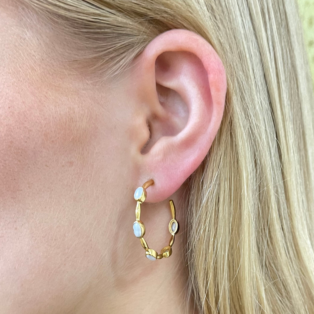 gold and pearl hoop earrings worn on model