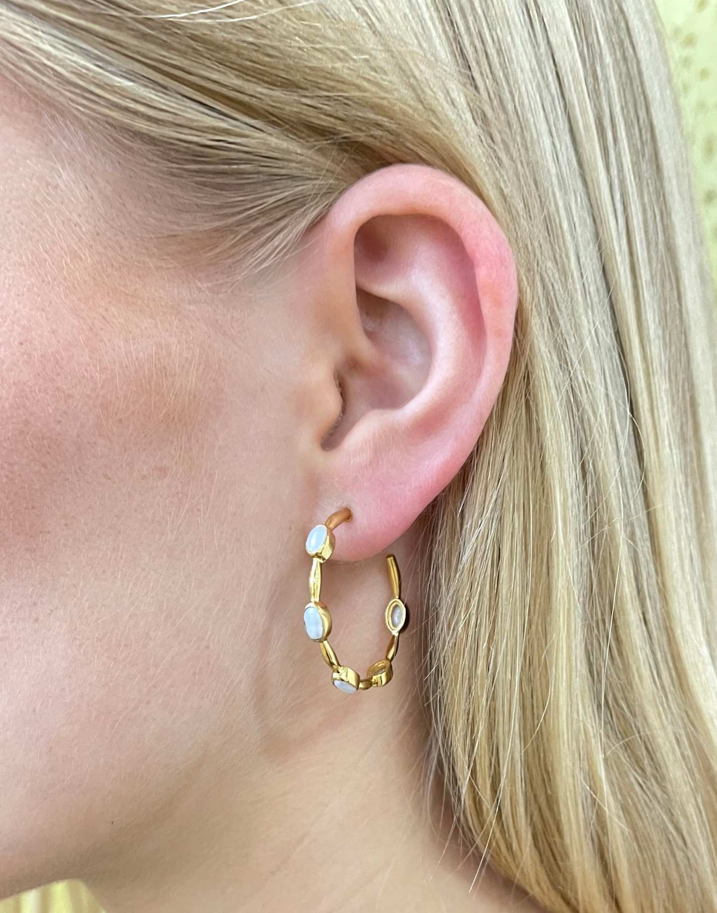 gold and pearl hoop earrings worn on model