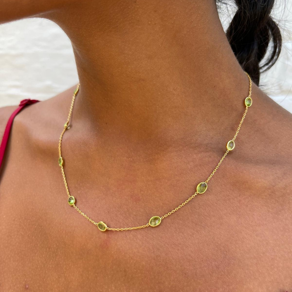 Gold peridot necklace on model