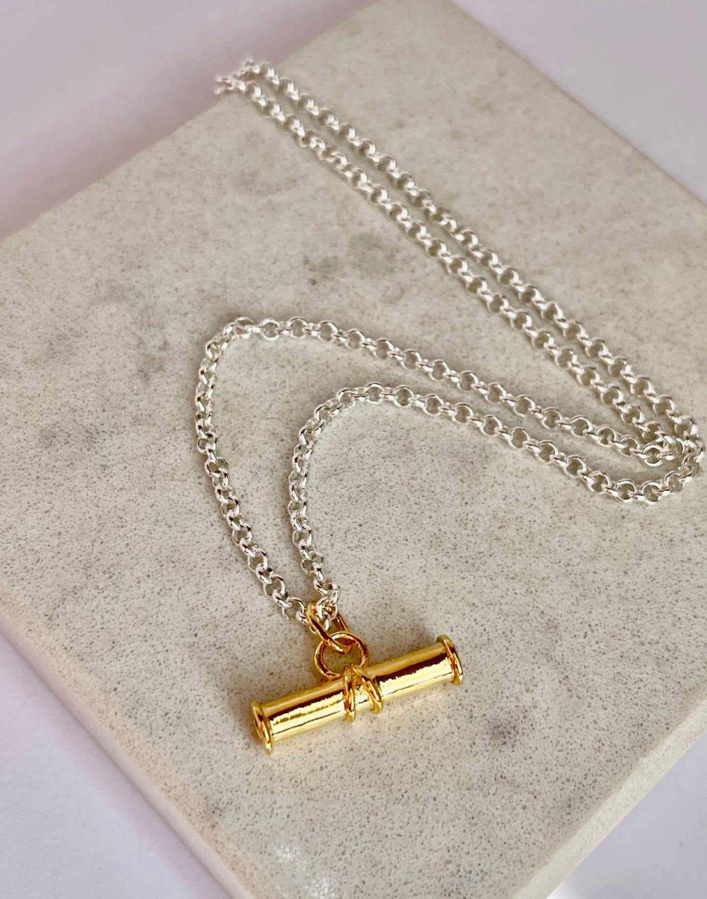 Gold T Bar on Silver Belcher Chain Necklace on a tile