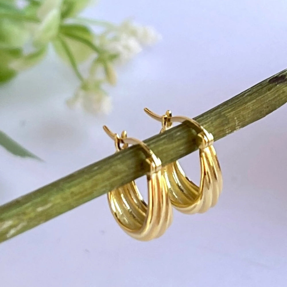 Grooved Gold Hoop earrings on flower