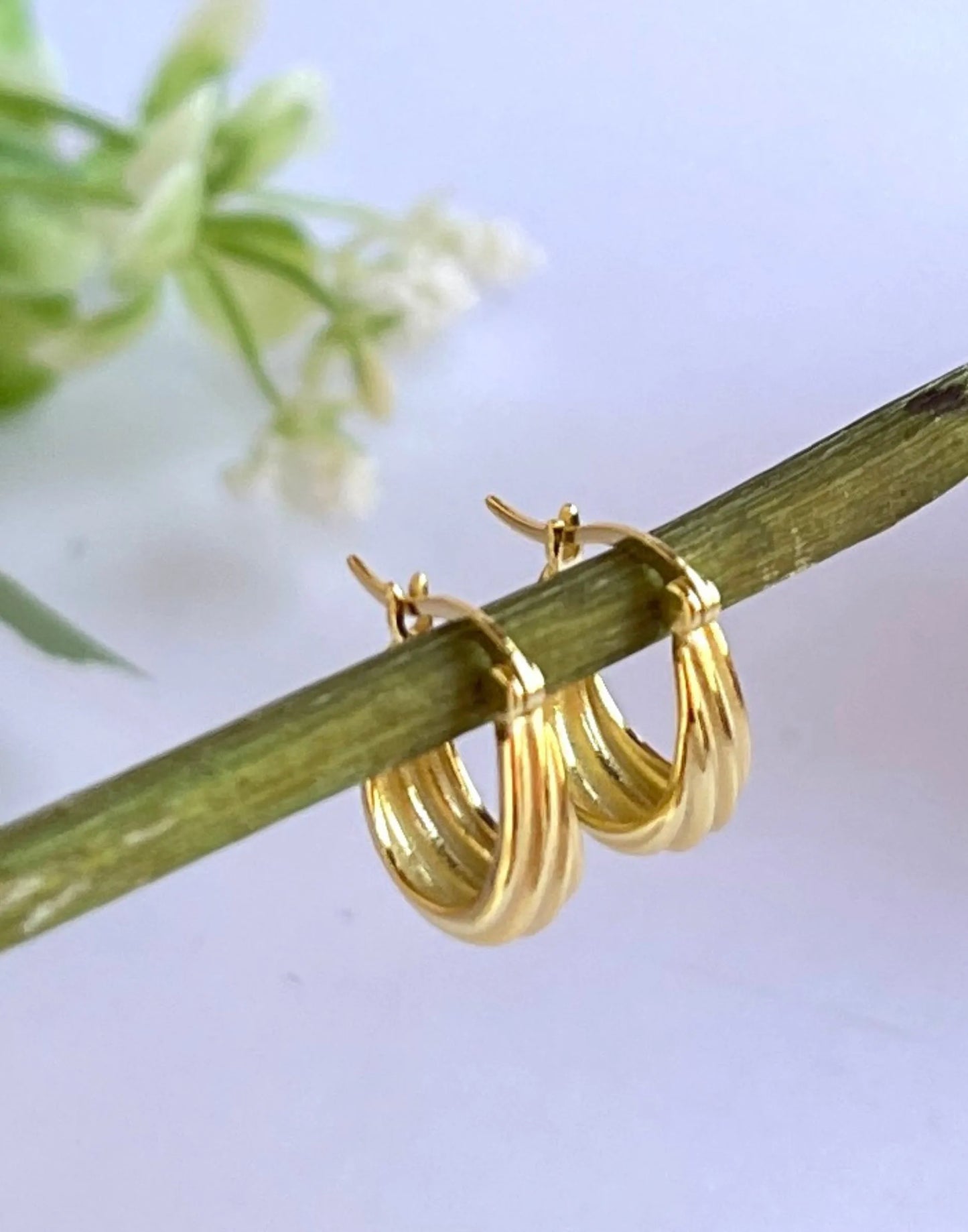 Grooved Gold Hoop earrings on flower