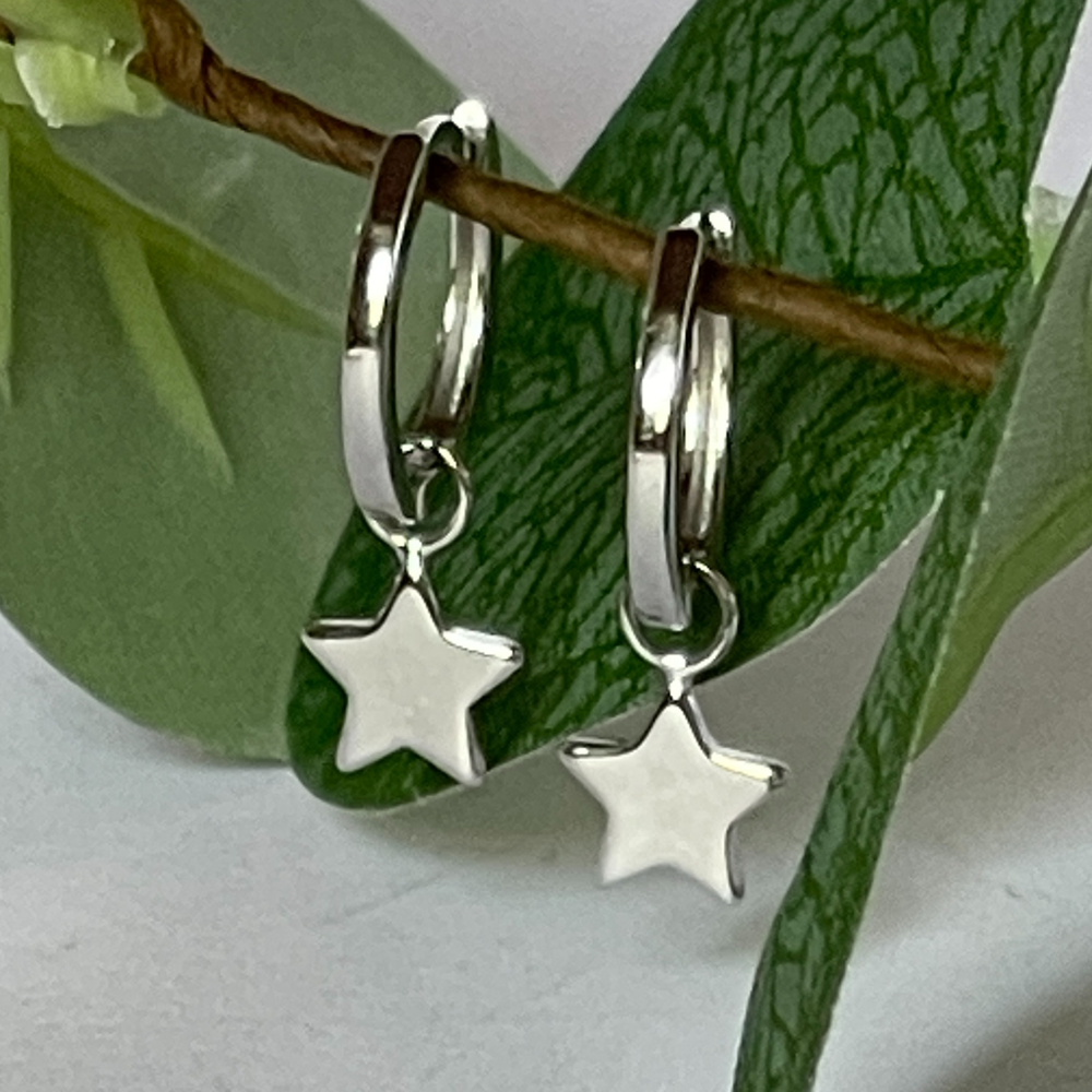 Silver huggie earrings with small star charm