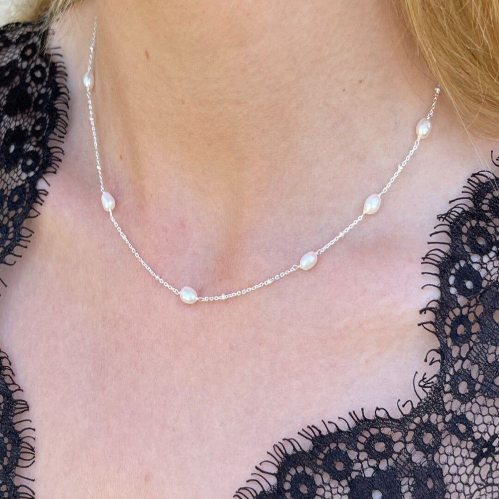 Silver and pearl necklace worn on model
