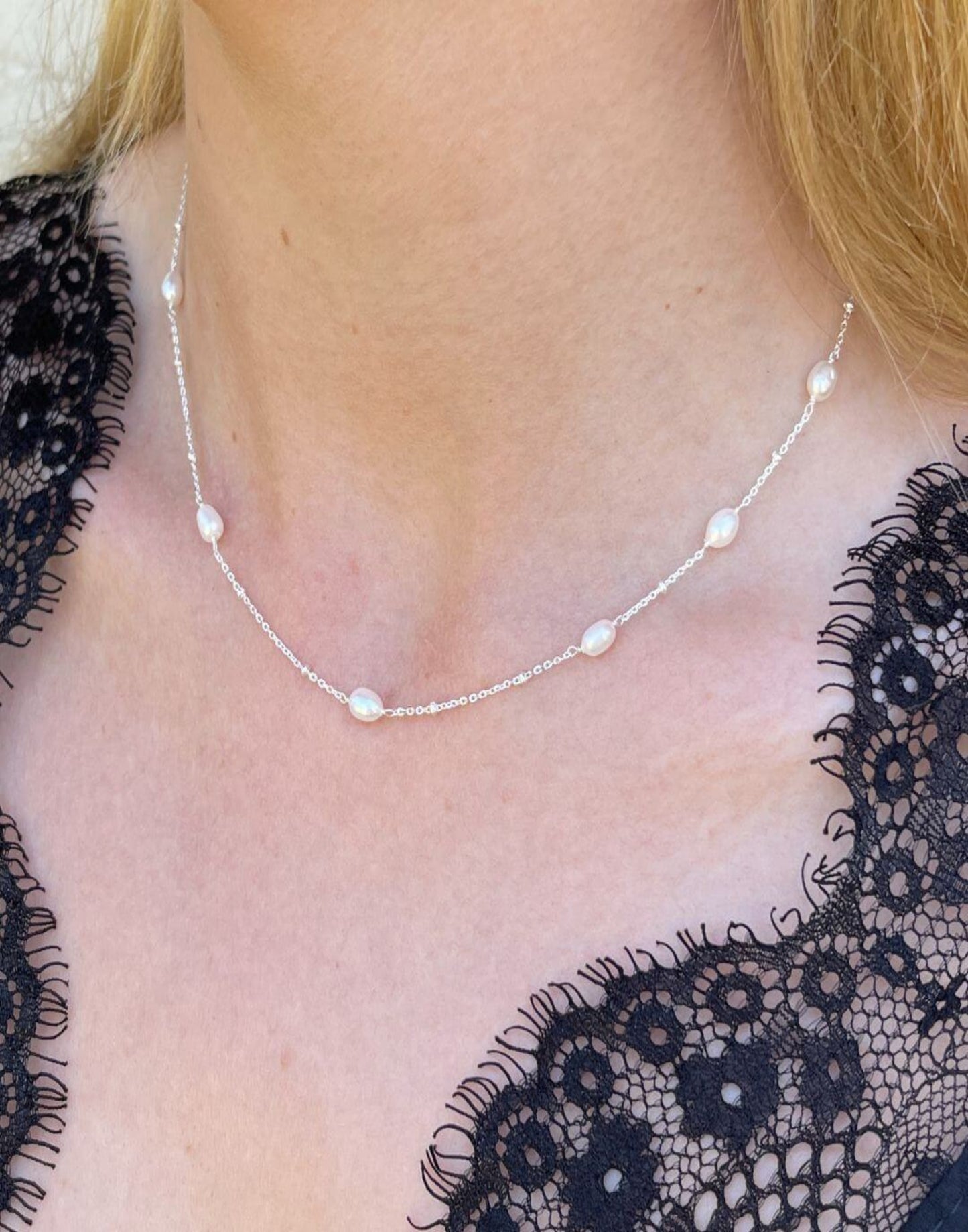 Silver and pearl necklace worn on model