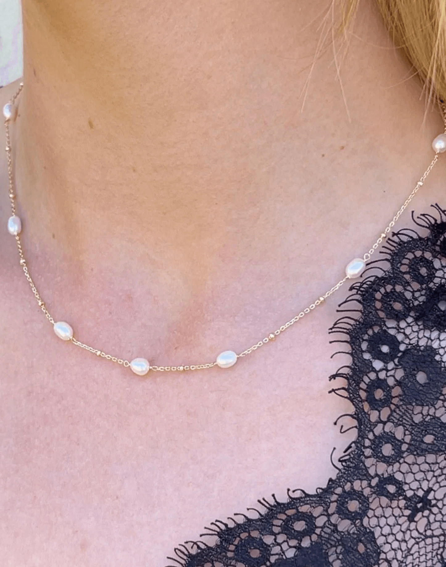 Gold and pearl necklace worn on model