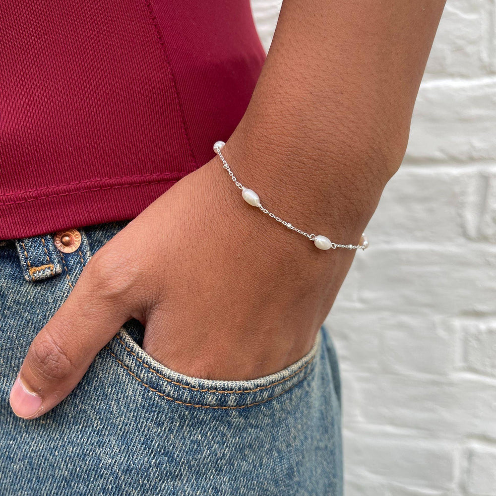 
                  
                    Model wears helena pearl and silver bracelet
                  
                