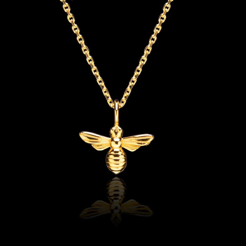 
                  
                    Honey Bee Gold pendant necklace on black background
                  
                