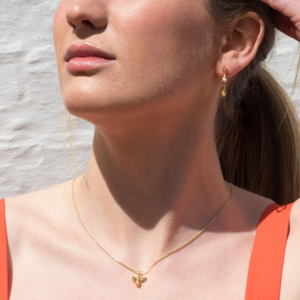model wears honey bee gold pendant necklace