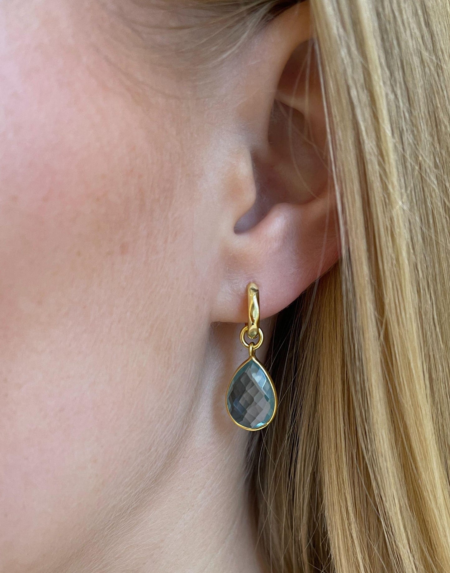 model wears kiera blue topaz drop earrings