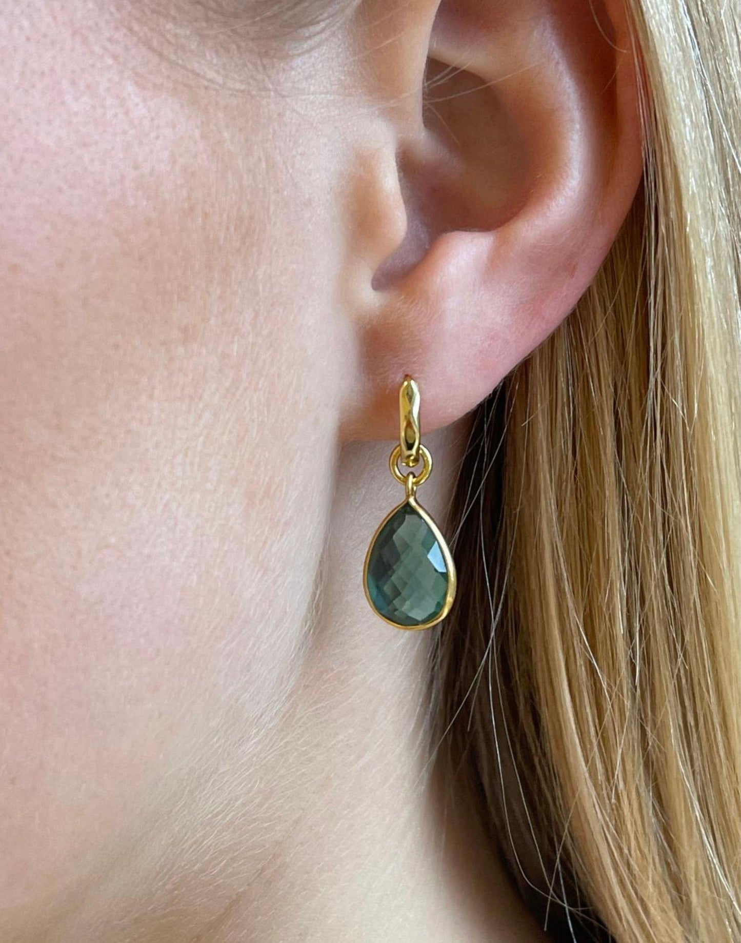 model wears forest green drop earrings