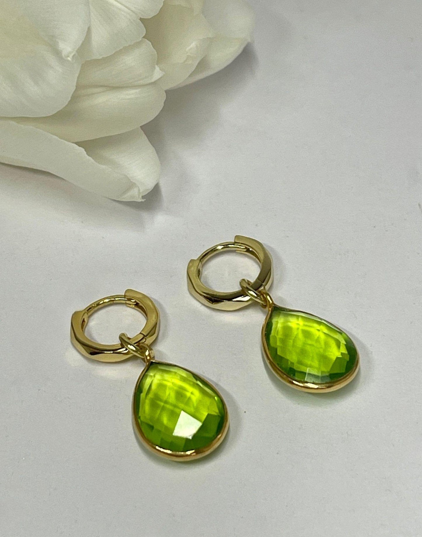 Kiera Verde Green Drop Earrings on a tile next to a Flutterby gift box