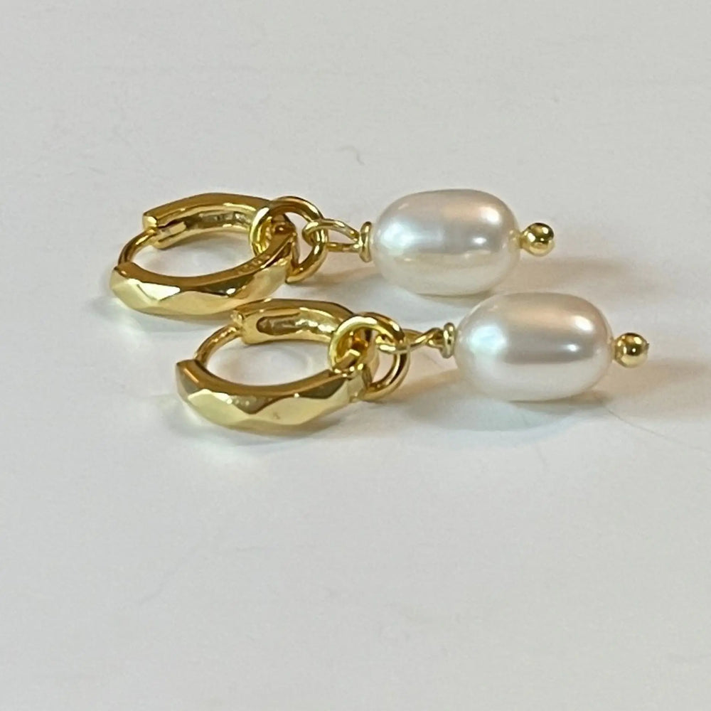 Kitty Gold pearl charm huggies on white background