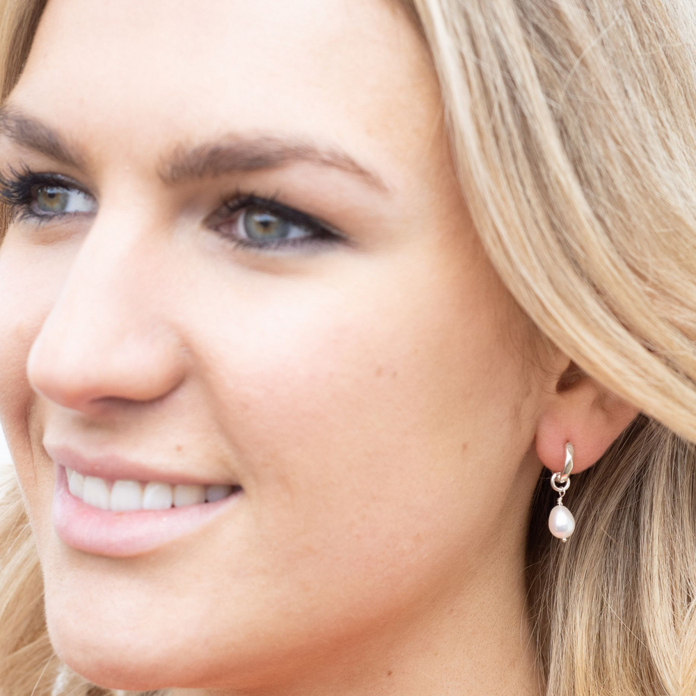 model wears Kitty silver charm huggie earrings