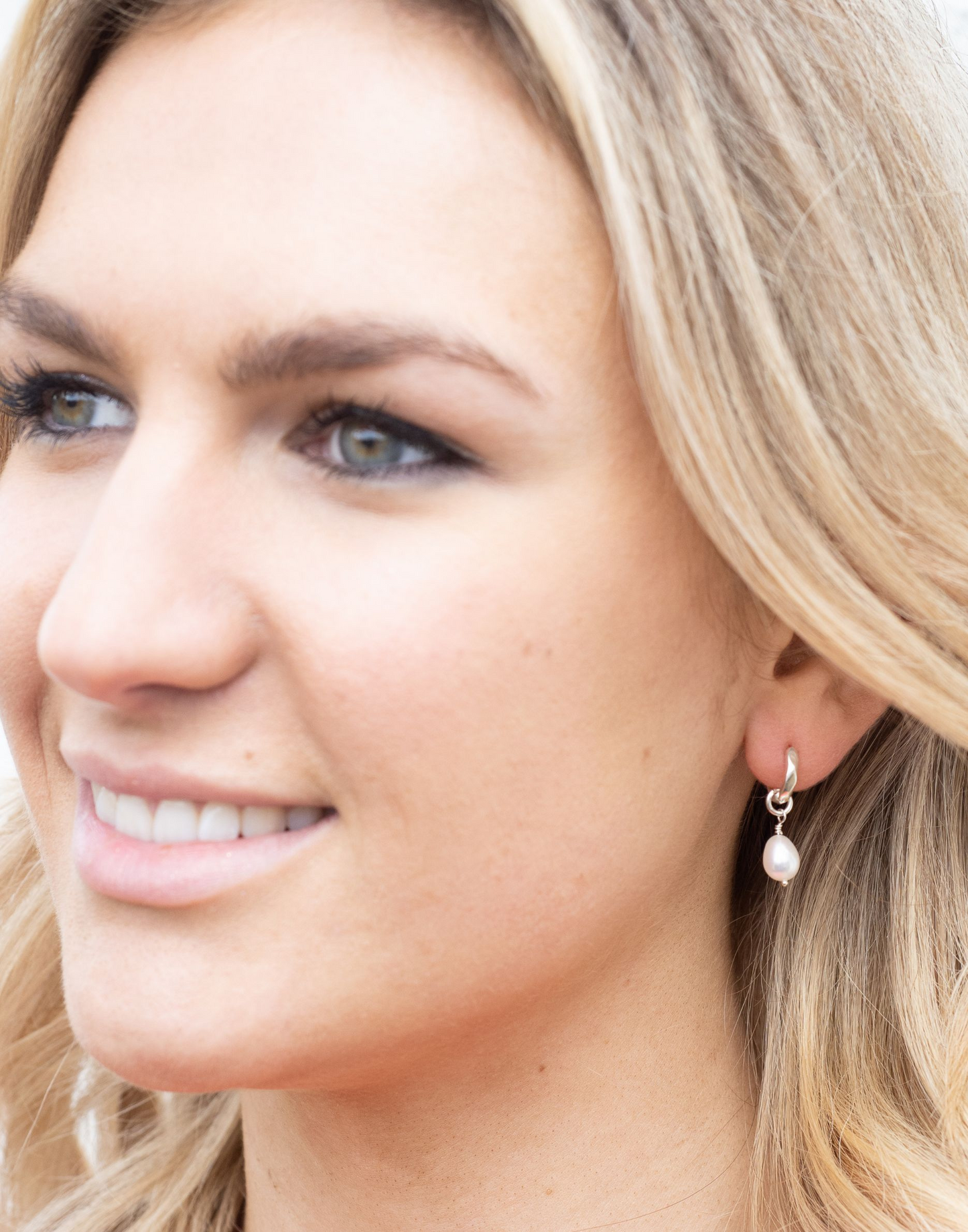 model wears Kitty silver charm huggie earrings