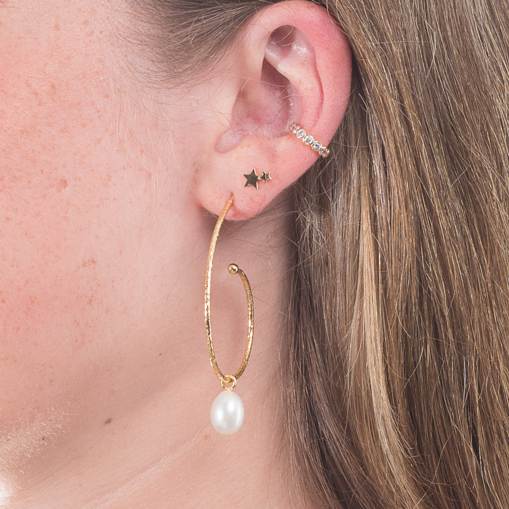 
                  
                    large gold hoop with pearl drop in ear
                  
                