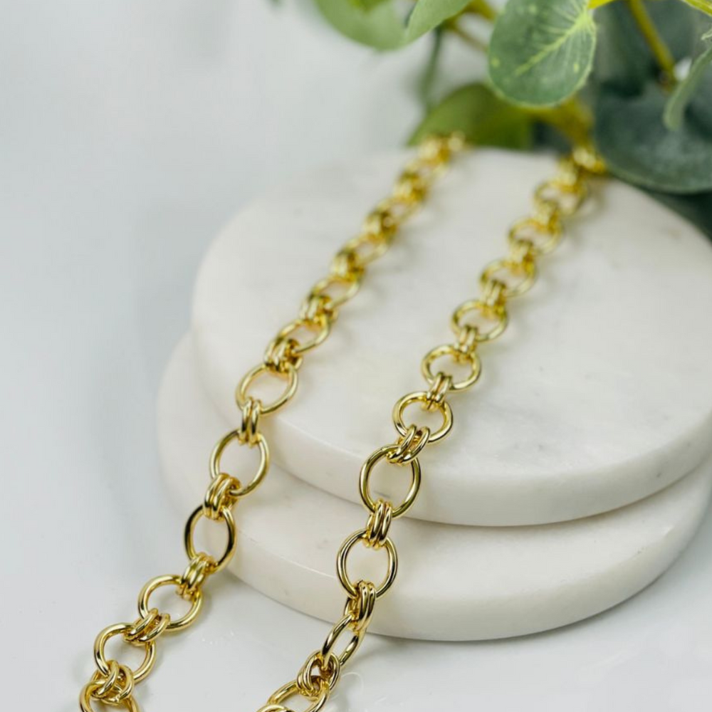 lizzy gold link necklace on tile