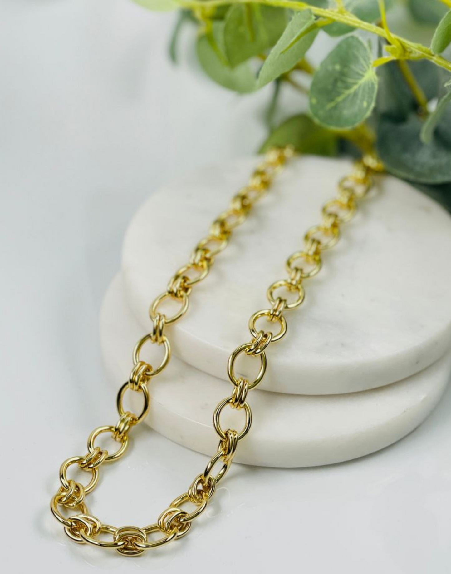 lizzy gold link necklace on tile