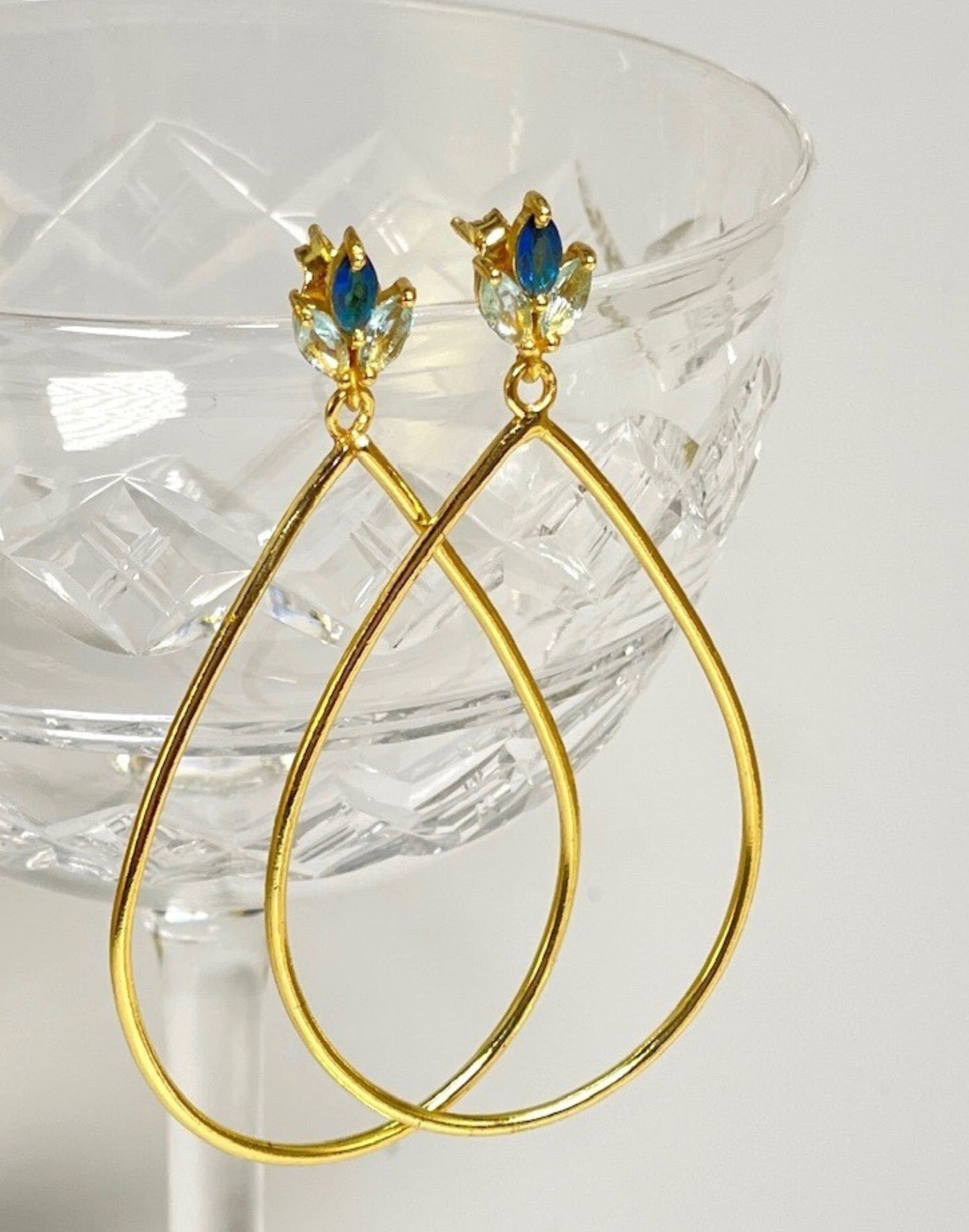 Lotus flower blue topaz gold earrings on glass