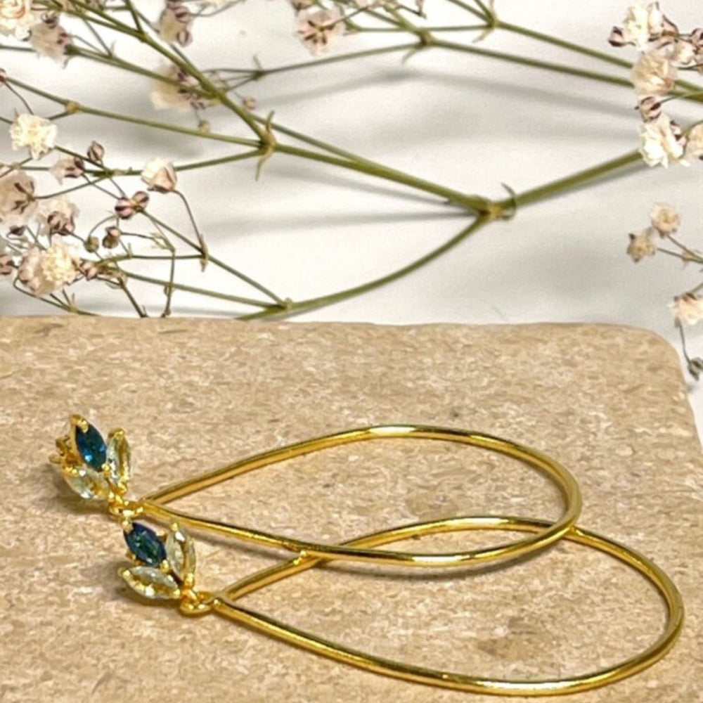 
                  
                    Lotus flower blue topaz gold earrings with flowers
                  
                