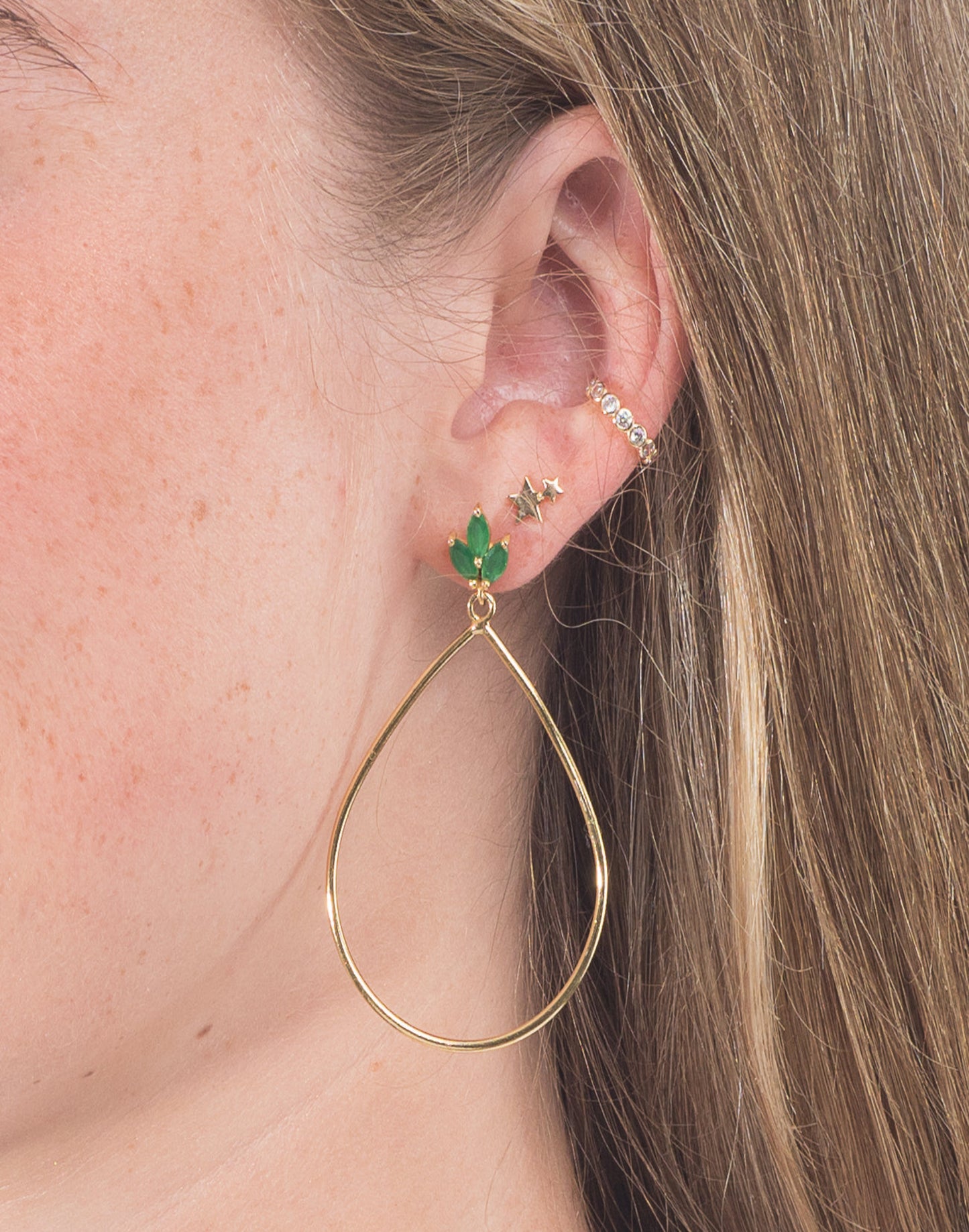Lotus flower green onyx gold earrings in model's ear