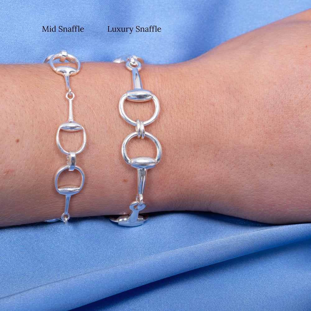 
                  
                    Model wears mid silver snaffle bracelet and luxury silver snaffle bracelet stacked together
                  
                