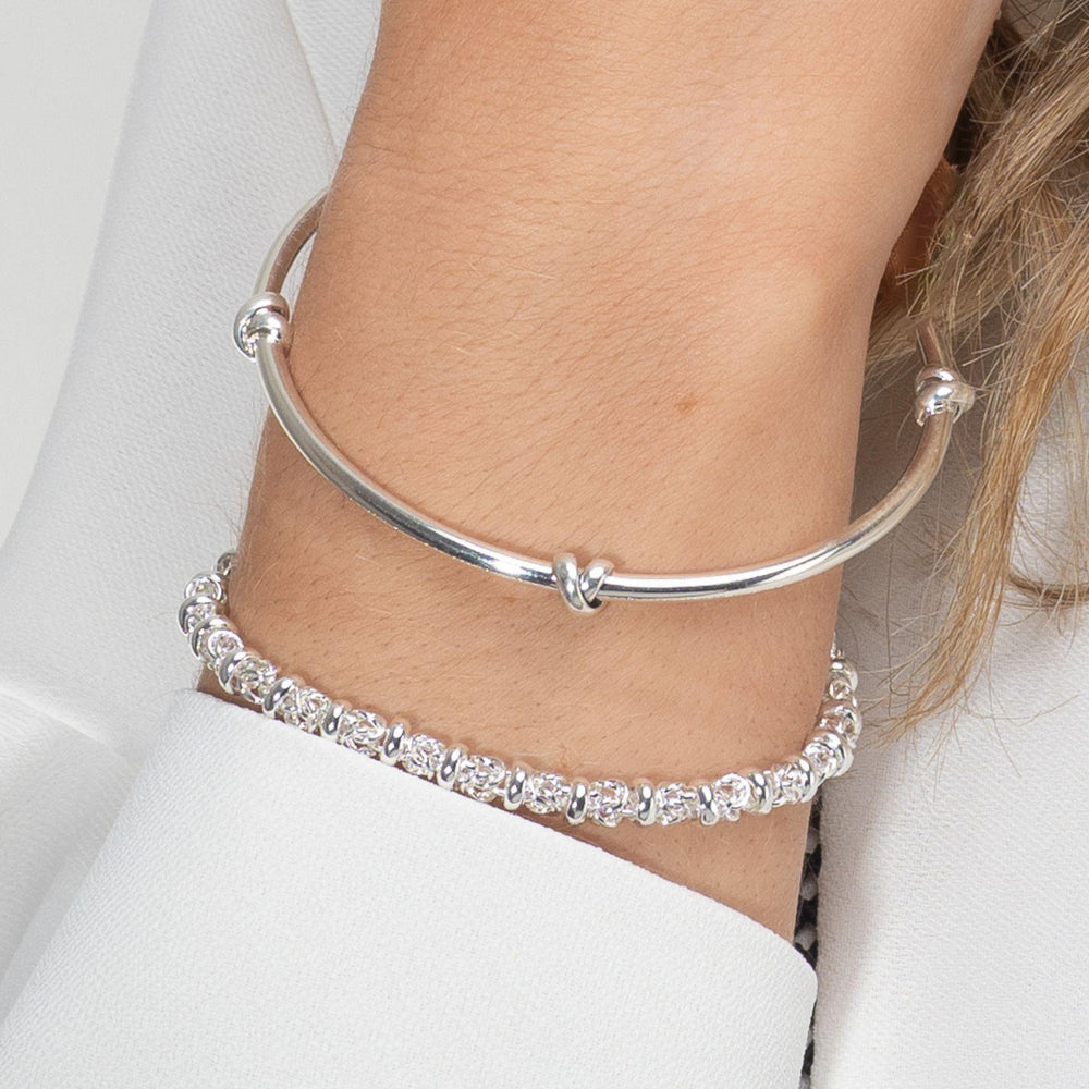 
                  
                    Model wears morton silver knot bangle with silver dee bracelet
                  
                