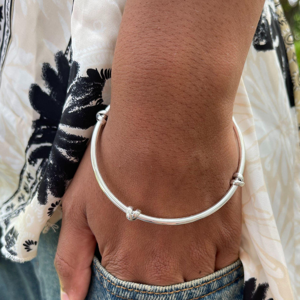Model wears morton silver knot bangle