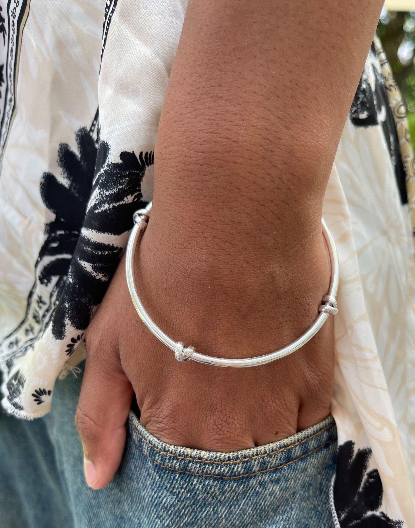 Model wears morton silver knot bangle