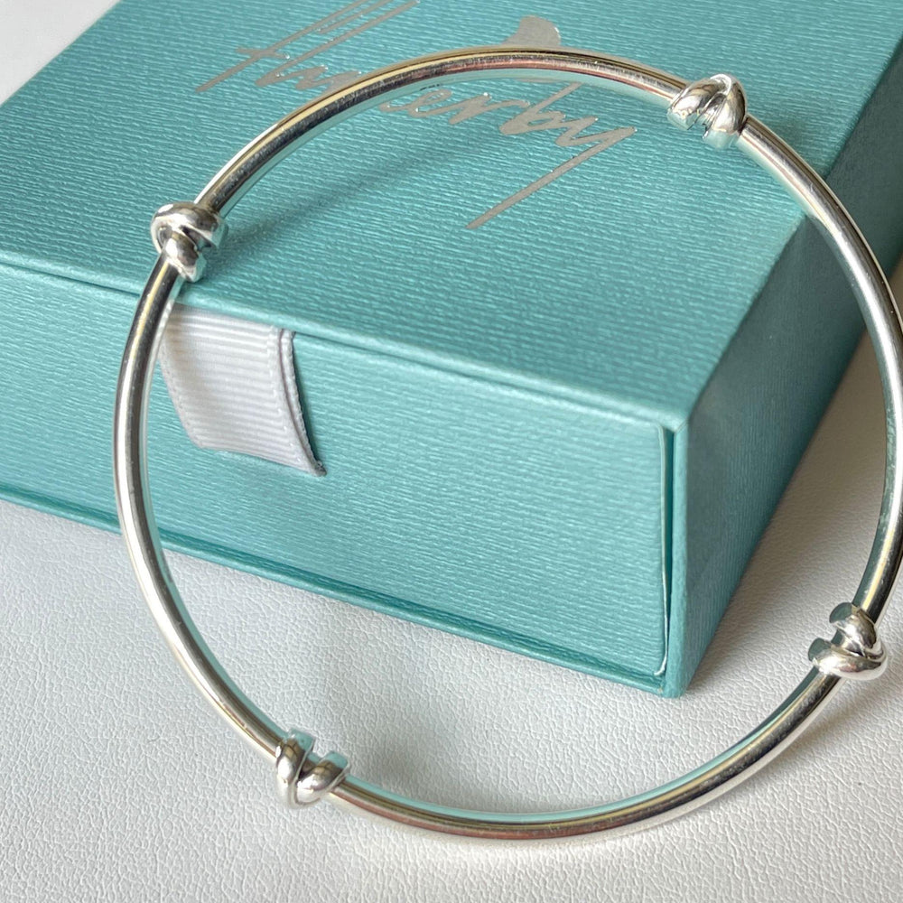  morton silver knot bangle resting on Flutterby gift box